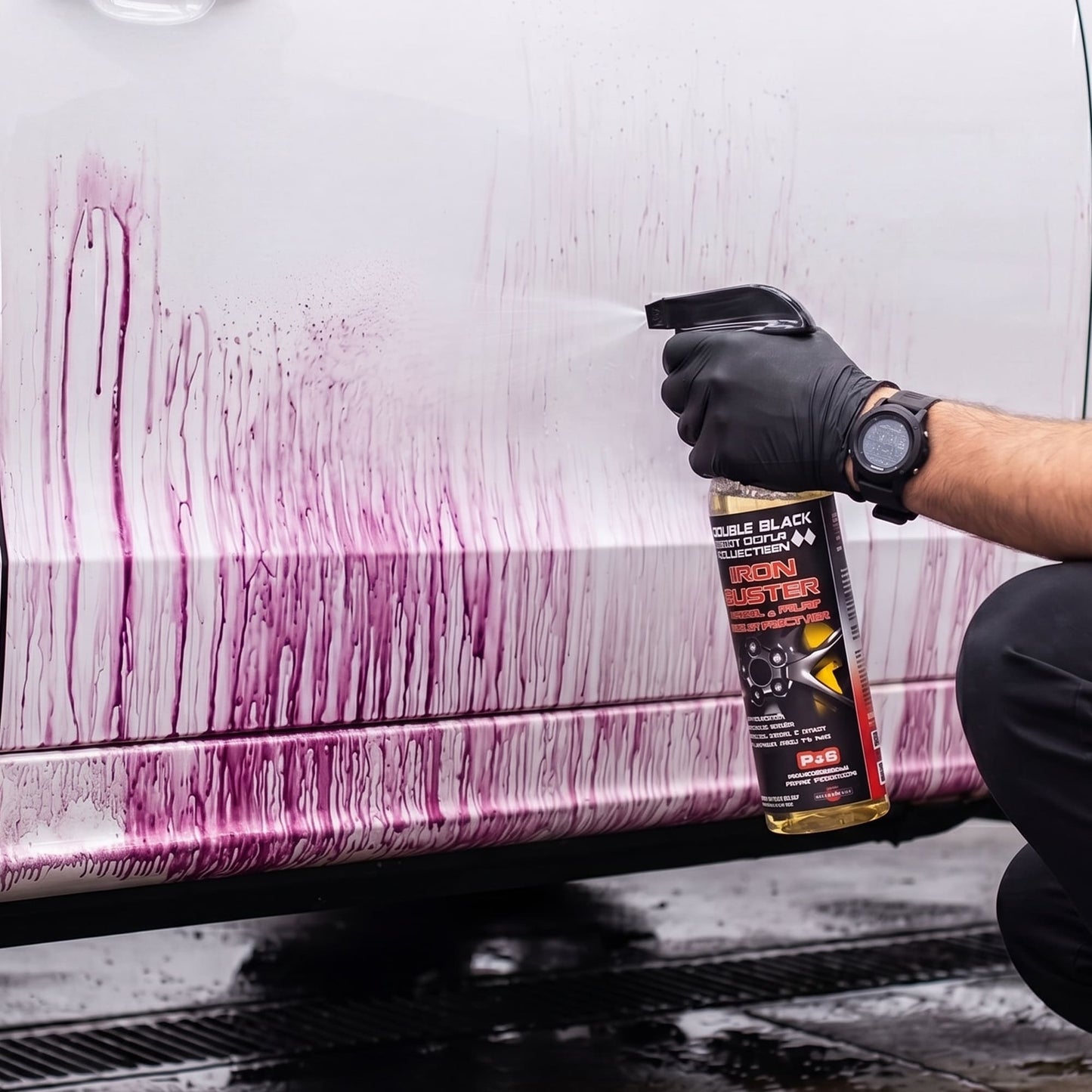 Detailer applying P&S Iron Buster decontamination spray to car paint