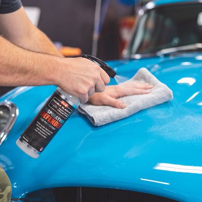 Detailer applying P&S Defender SiO2 to car paint with microfiber applicator